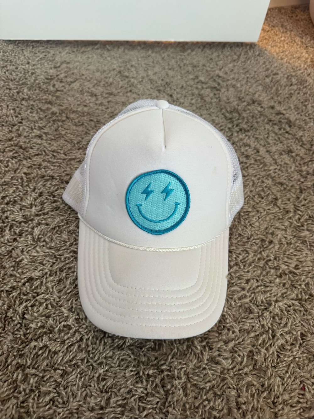White Trucker Hat with Teal Smiley Patch